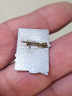 USSR hammer and sickle pin with rifle, close-up