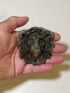 Antique bronze lion head mount with detailed mane and dark green patina