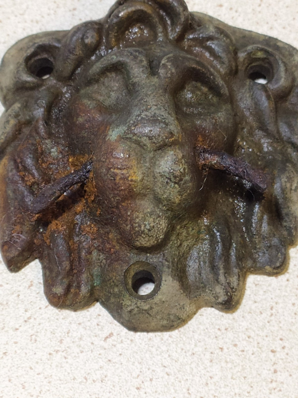 Antique bronze furniture mount, cast lion head relic, angled view