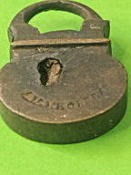 Miniature brass padlock held in fingers for scale – detail 6
