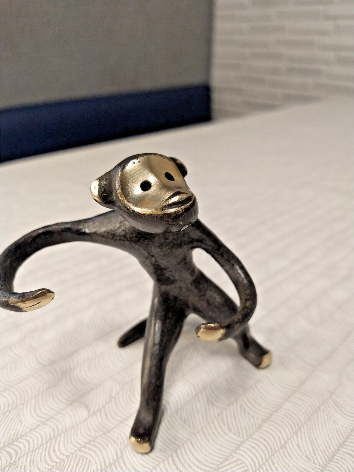 Bronze monkey salt and pepper caddy seen from the side