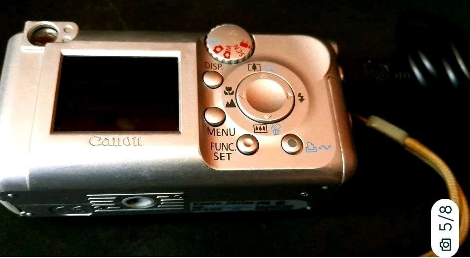 Vintage Canon PowerShot with wrist strap and interface cable