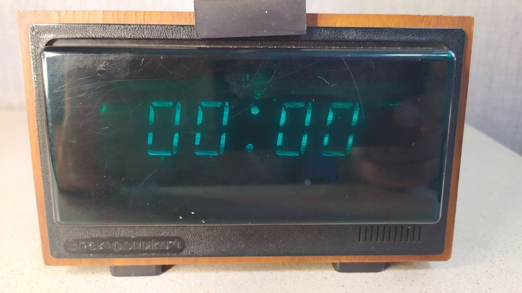 Vintage Soviet VFD clock with bright green glow and wood-veneer case