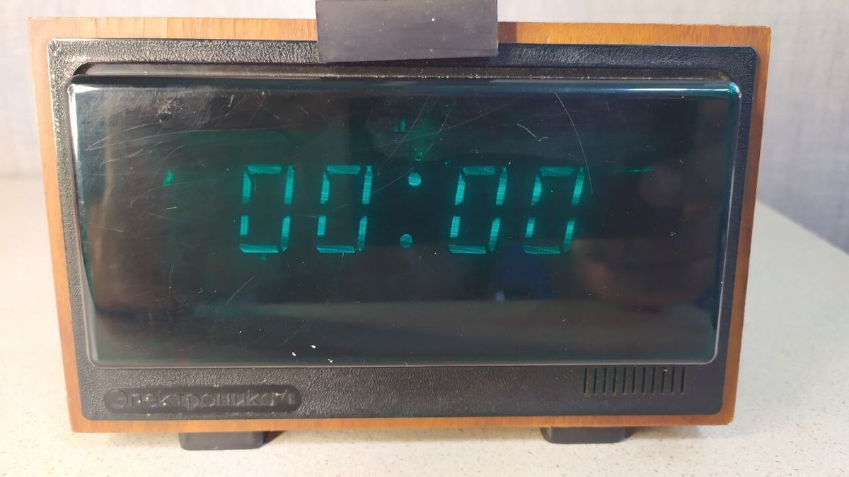 Vintage Soviet VFD clock with bright green glow and wood-veneer case