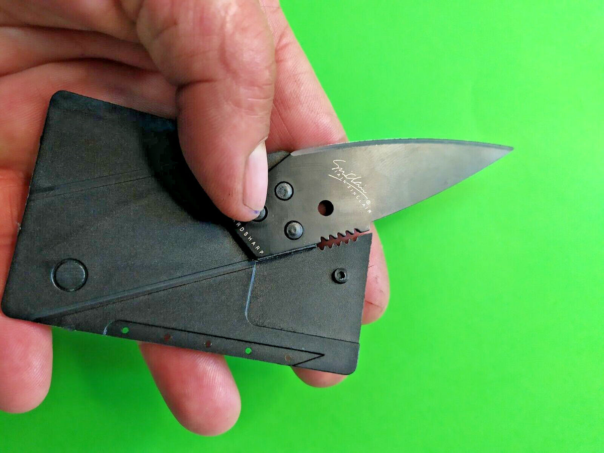 Black polypropylene card knife in protective plastic sleeve