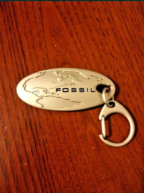 Fossil world map keychain in brushed silver tone metal with lobster clasp