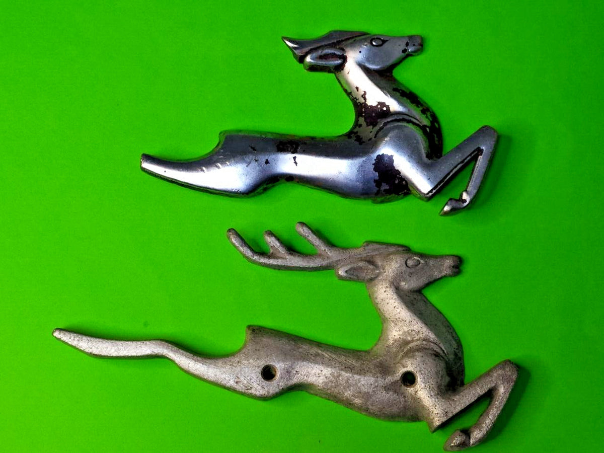 Leaping deer emblem with broken antlers, drilled hole and heavy patina