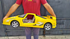 Giant yellow toy racing supercar Shooter with racing decals, about 35 inches long