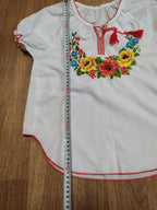 Ukrainian folk blouse laid flat with measuring tape