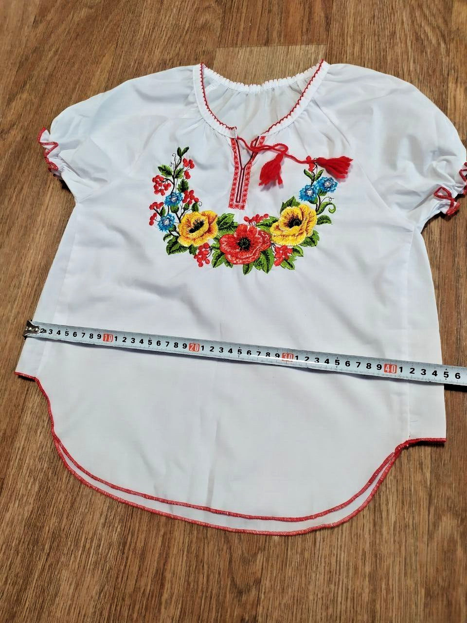 Ukrainian folk blouse laid flat with measuring tape – detail 7