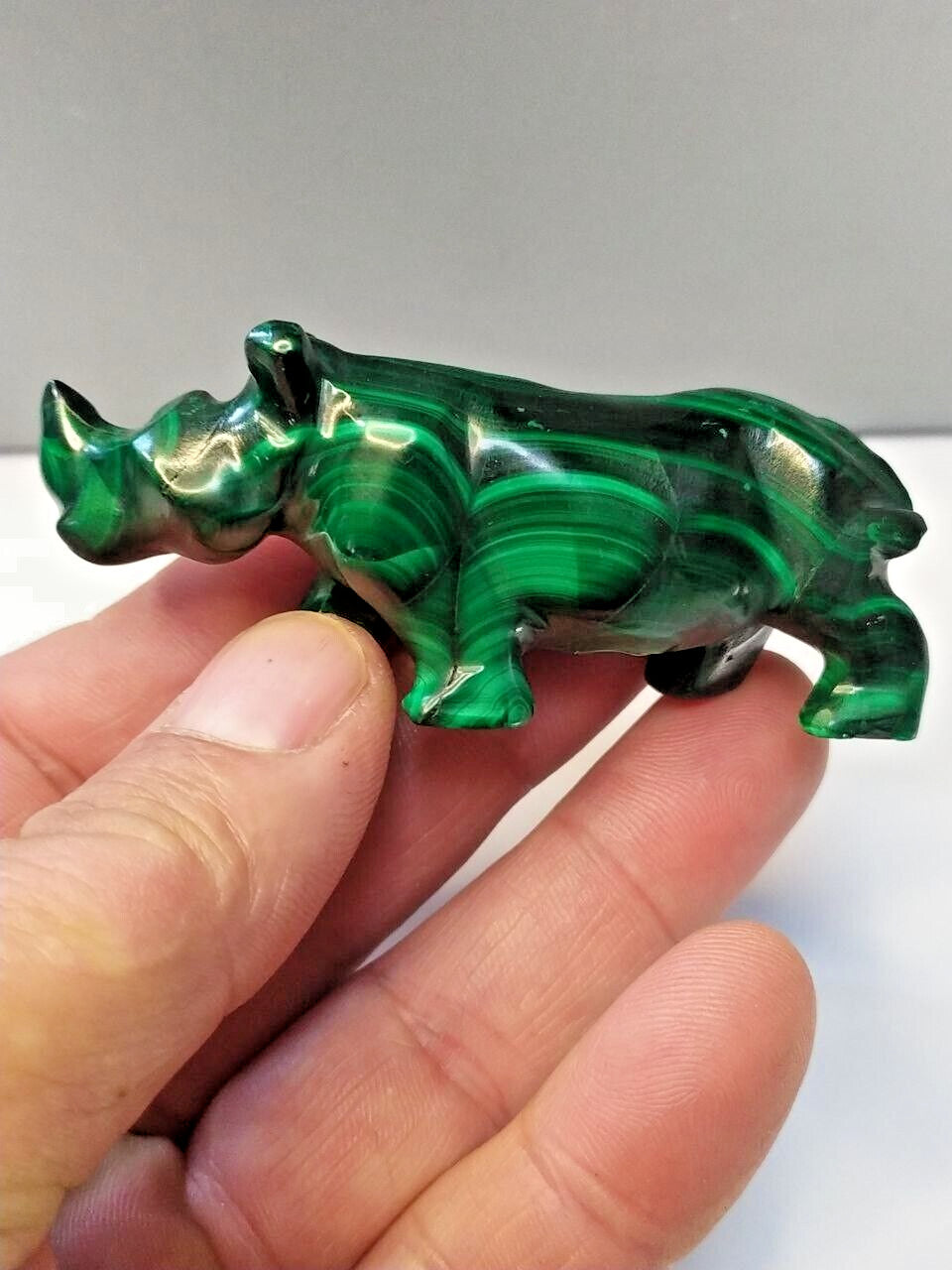 Malachite animal carving of a rhino in side view