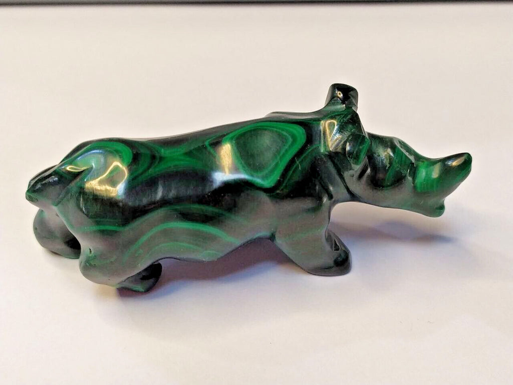 Natural malachite banding close-up on the carved rhinoceros