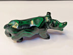 Natural malachite banding close-up on the carved rhinoceros