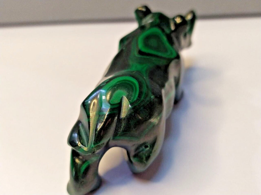 Natural malachite banding close-up on the carved rhinoceros – detail 7