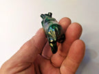 Green stone rhino figurine on a scale showing 106 g – detail 9