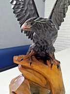 Wooden eagle figurine dark brown wings and light amber base