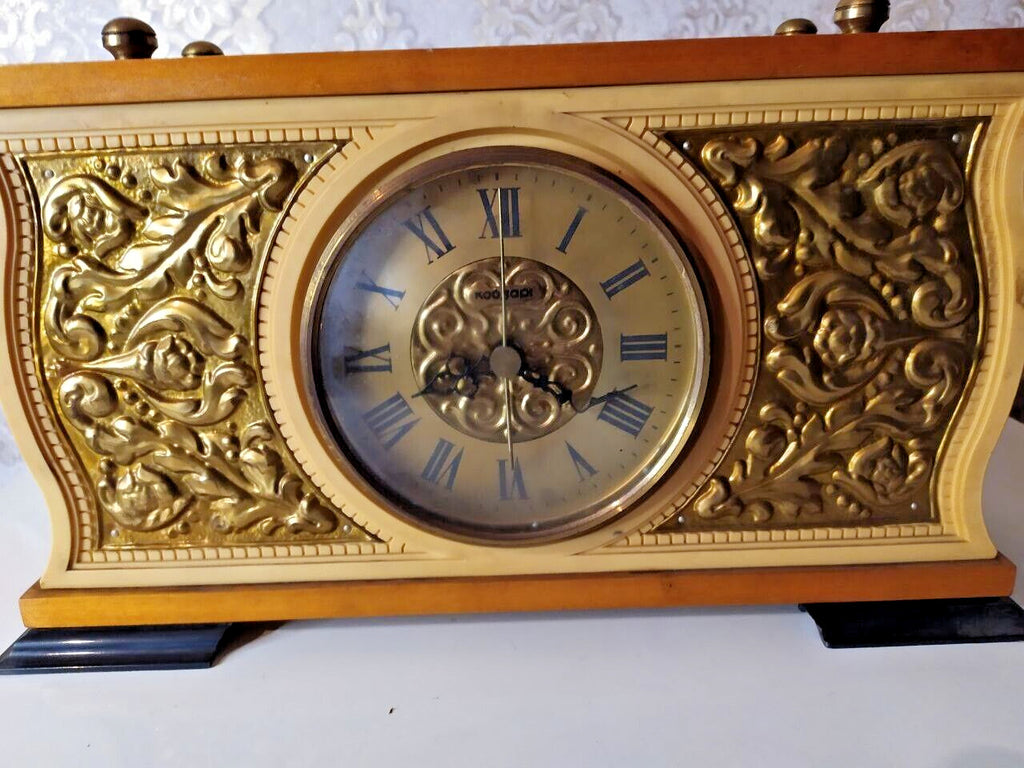 Soviet mantel clock dial with Roman numerals and gold-tone floral relief