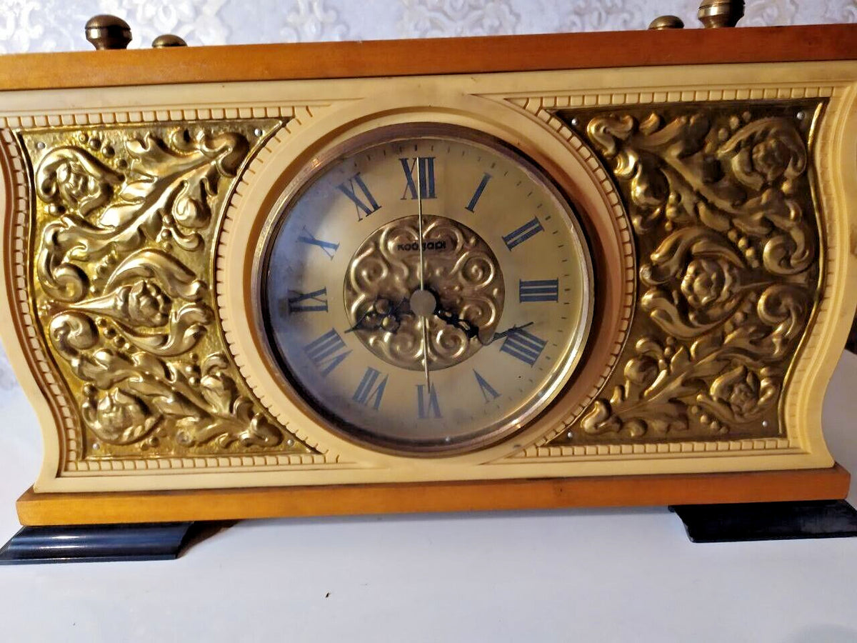 Soviet mantel clock dial with Roman numerals and gold-tone floral relief