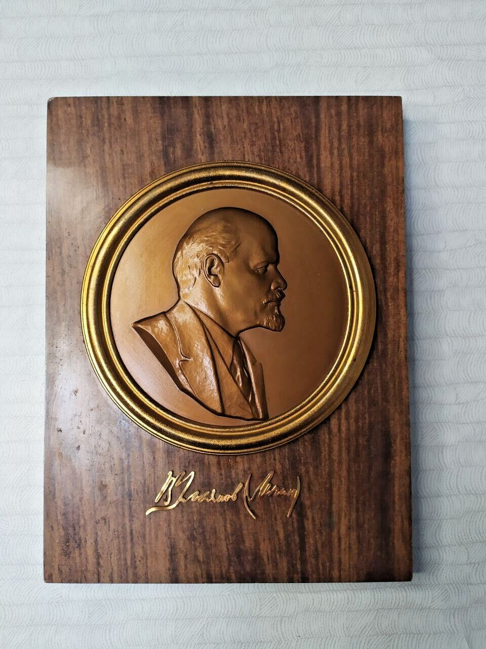 Soviet wall decor plaque showing edge wear on the base