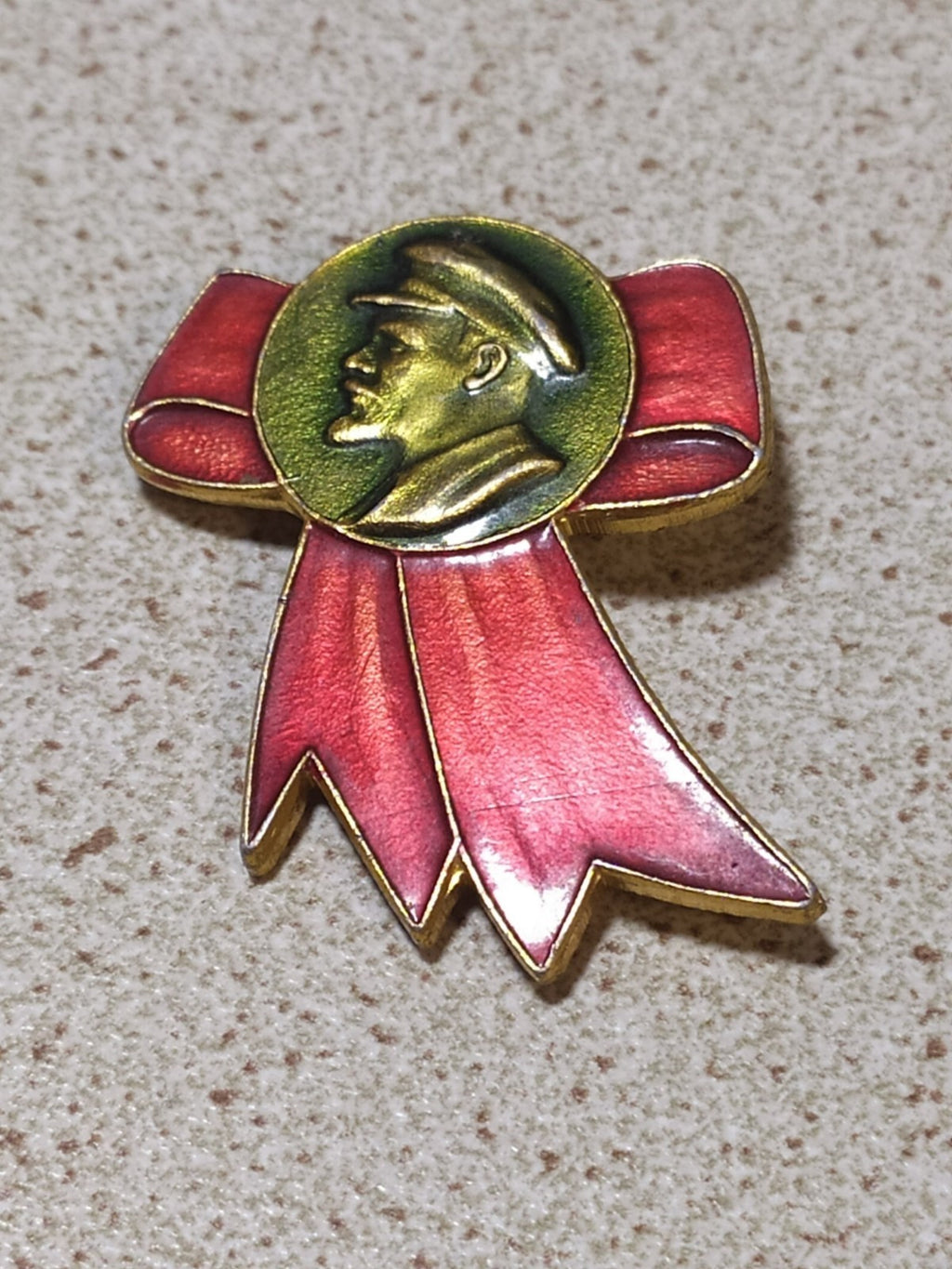 Soviet Lenin profile badge with red ribbon bow, close view