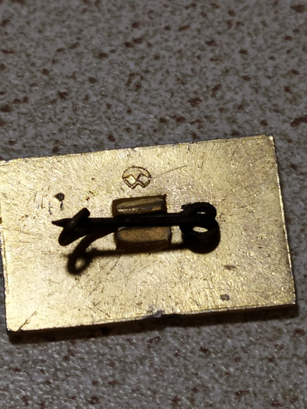 Vintage Lenin pin photographed for size comparison