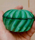 Malachite glass trinket box in swirled green pressed glass with starburst lid