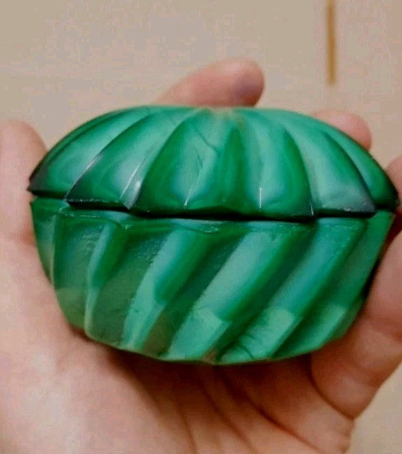 Malachite glass trinket box in swirled green pressed glass with starburst lid