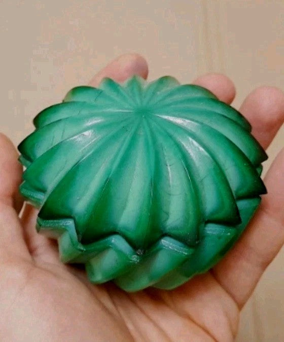 Green slag glass box lid with 16-point starburst pattern