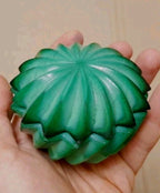 Green slag glass box lid with 16-point starburst pattern