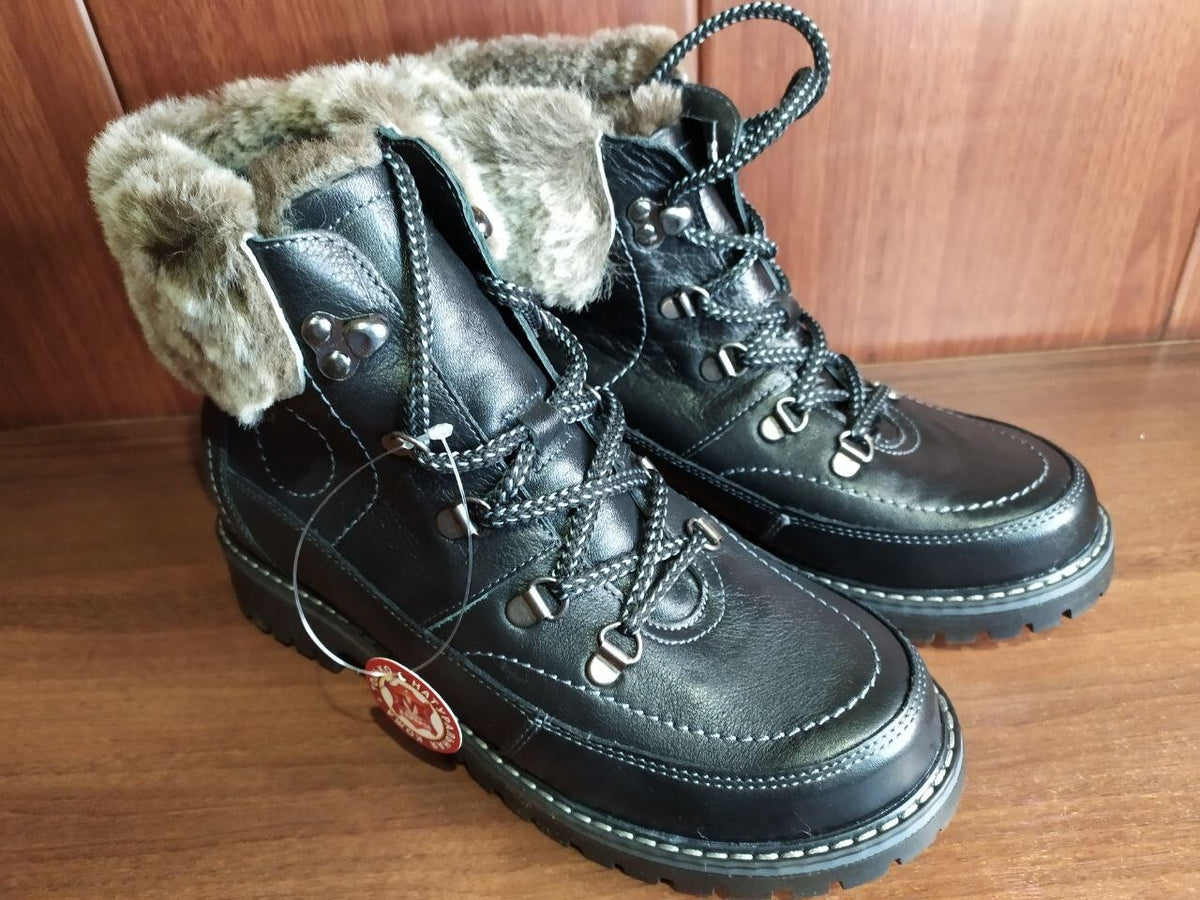 Black lace-up combat-style ankle boots with contrast stitching and D-ring eyelets