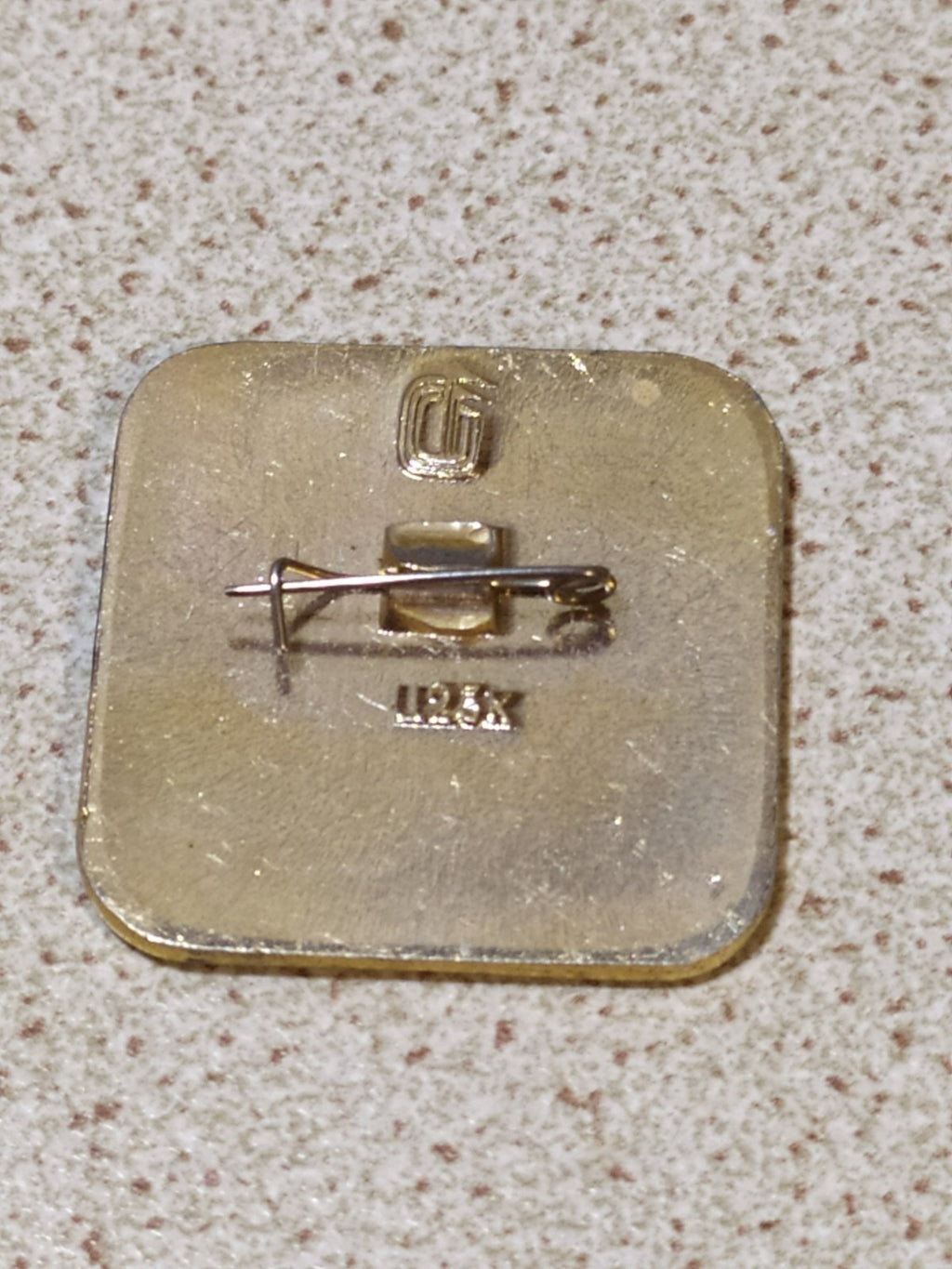Reverse side of old Soviet Olympic enamel badge with pin fitting