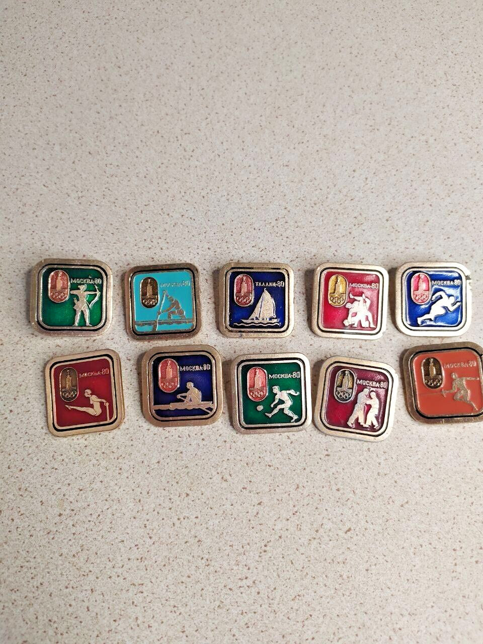 Reverse of Soviet Olympic enamel pins with safety pin clasps