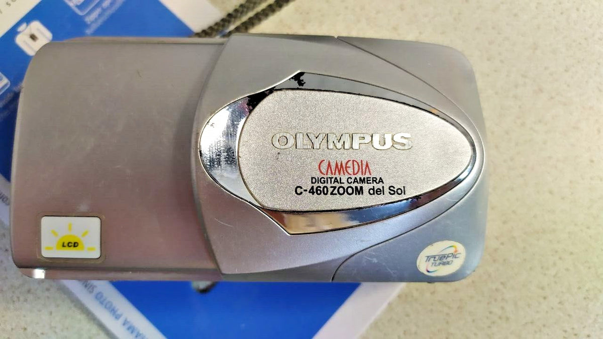 Vintage Olympus digital camera with sliding lens cover