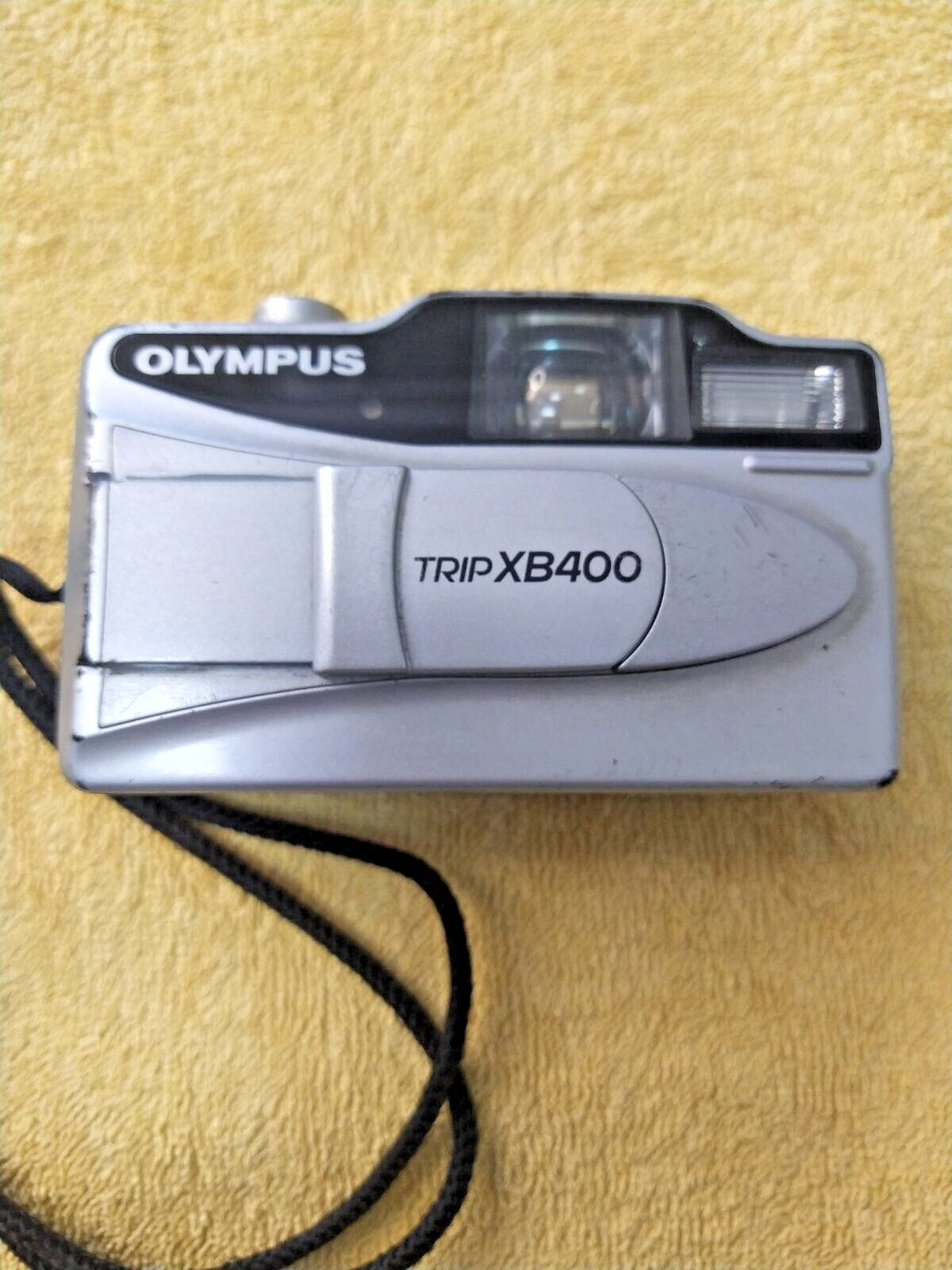 Olympus Trip XB400 35mm point and shoot film camera in silver with wrist strap