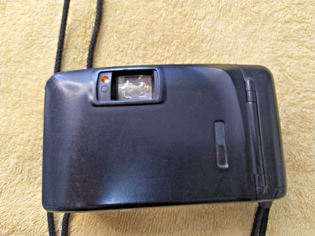 Retro compact 35mm camera showing scuffs on silver finish
