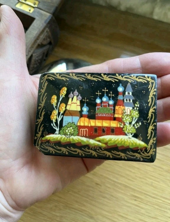 Palekh lacquer box with hand-painted fairytale landscape, churches and gold trim