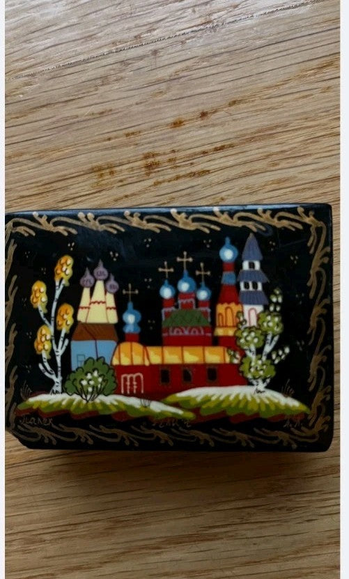 Hand painted jewelry box lid with artist signature at the bottom of the painting