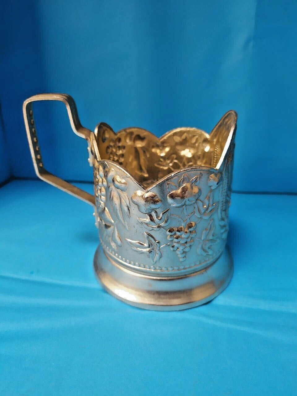Vintage podstakannik with grapes and floral motifs in pressed aluminum