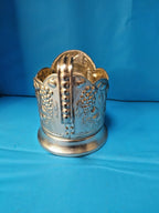 Soviet tea glass holder side view showing the hammer and sickle design