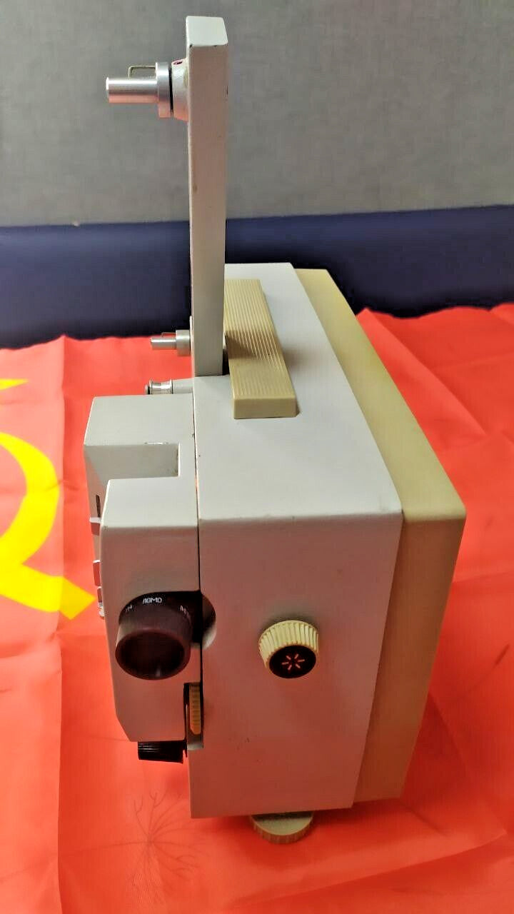 Vintage Soviet movie projector with carrying handle and foldable reel arm