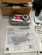 Red Canon PowerShot A470 7.1MP CCD digital camera in burgundy red with original box and accessories