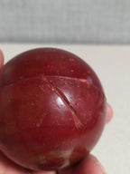 Cherry red bakelite sphere showing swirl marble pattern on one side – detail 11