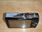 Canon Digital IXUS 65 front view with lens – detail 7