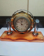 Visible gears of a Soviet mechanical clock movement through acrylic