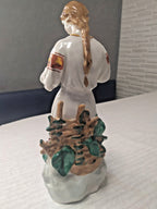 Delicate fingers and daisy of vintage Ukrainian girl porcelain figurine