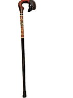 Detailed raven head handle with feather texture on a wooden cane