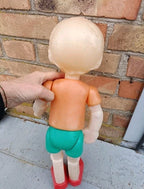 Soviet Pinocchio doll in red felt vest with white pom-poms and red shoes