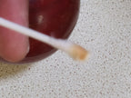 Cherry red bakelite sphere showing swirl marble pattern on one side – detail 17