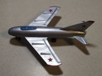 Vintage Soviet toy jet with blue-painted canopy and red star on the tail fin