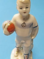 Hand-painted face and gilded boots on young Soviet soccer player figurine